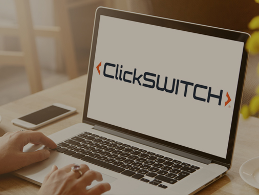 Person typing on laptop with ClickSWiTCH logo